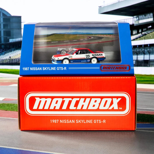Matchbox 1987 Nissan Skyline GTS-R model car packaging on a race track background
